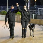 Trainer David Burnett and handler Martina Kirillidis head toward the presentation area with Simon Told Helen.