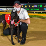 Typhoon Sammy and trainer Jason Thompson in front of the semaphore board after his track record run.